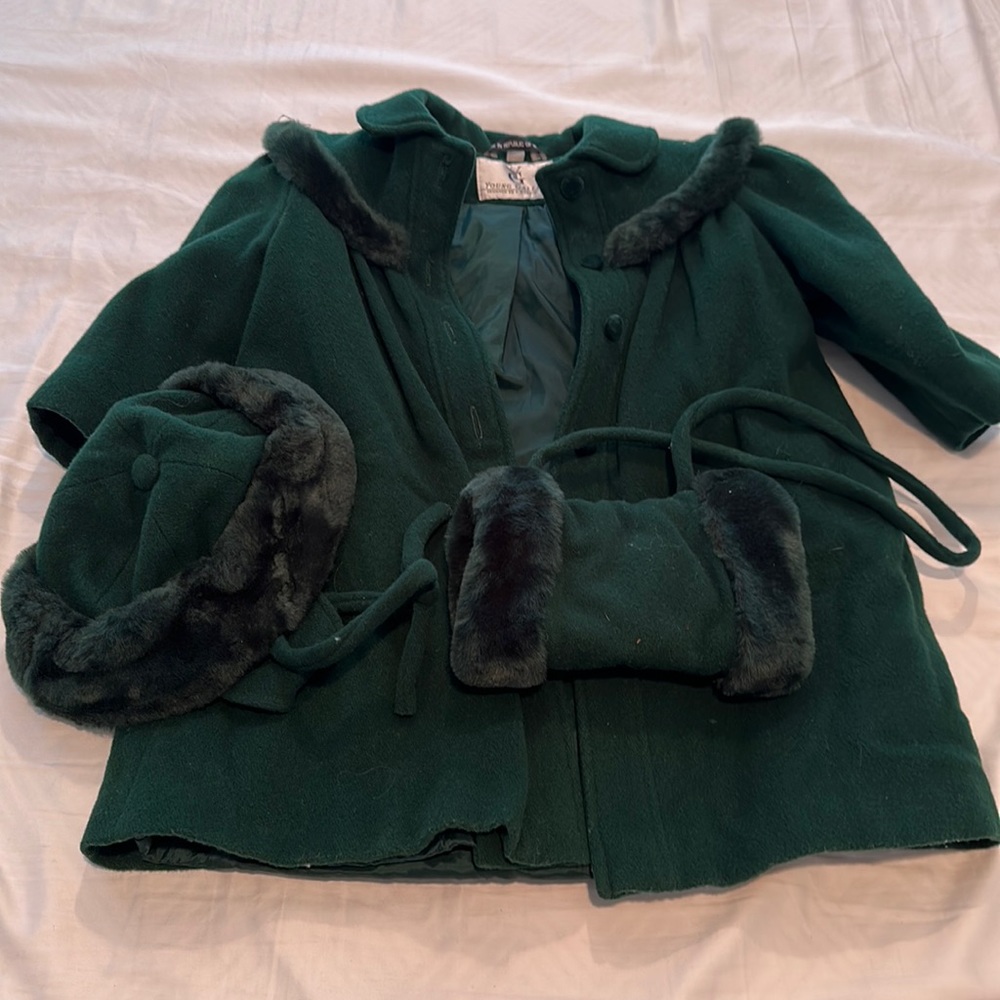 Hunter green jacket, hat, and muff.